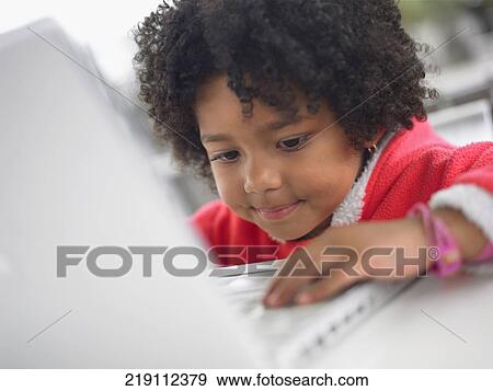 Close-up of a girl using a laptop View Large Photo Image Stock Photo - Close-up of a girl using a laptop. Fotosearch