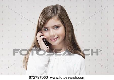 Close-up of a girl using a mobile phone View Large Photo Image Stock Image - Close-up of a girl using a mobile phone. Fotosearch