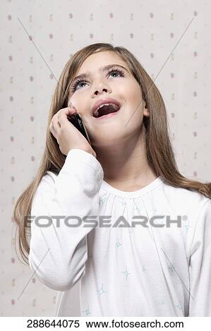 Close-up of a girl using a mobile phone View Large Photo Image Stock Photography - Close-up of a girl using a mobile phone. Fotosearch