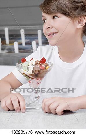 Close-up of a girl with ice cream View Large Photo Image Stock Photograph - Close-up of a girl with ice cream. Fotosearch