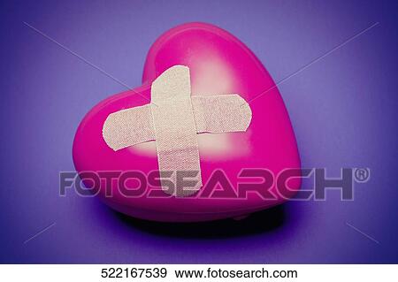 Close-up of a heart balloon with a bandage on it View Large Photo Image Stock Photo - Close-up of a heart balloon with a bandage on it. Fotosearch