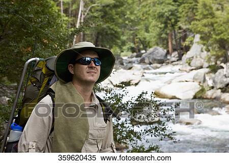 Close-up of a hiker standing at the riverside View Large Photo Image Stock Photography - Close-up of a hiker standing at the riverside. Fotosearch