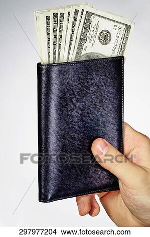 Close-up of a human hand holding a wallet with us dollar sticking out View Large Photo Image Picture - Close-up of a human hand holding a wallet with us dollar sticking out. Fotosearch