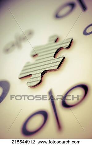 Stock Image - Close-up of a jigsaw piece with percentage signs. Fotosearch