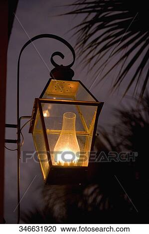 Stock Image - Close-up of a lamppost lit up at night. Fotosearch