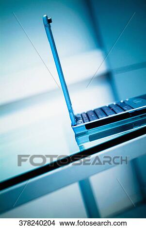 Close-up of a laptop on a table View Large Photo Image Picture - Close-up of a laptop on a table. Fotosearch