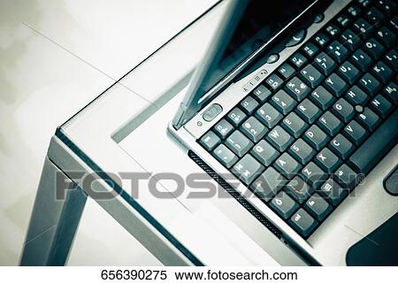 Close-up of a laptop on a table View Large Photo Image Stock Photography - Close-up of a laptop on a table. Fotosearch