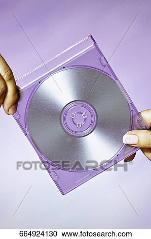Stock Image - Close-up of a man and a woman holding a compact disc. Fotosearch