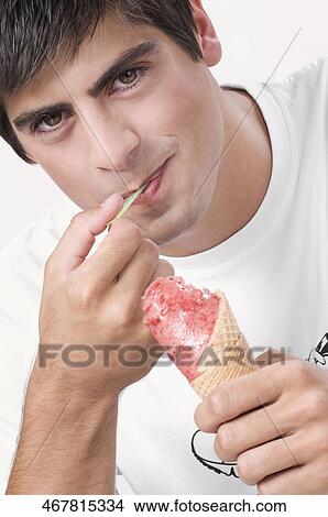 Close-up of a man eating an ice cream View Large Photo Image Picture - Close-up of a man eating an ice cream. Fotosearch