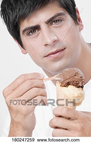 Close-up of a man eating an ice cream View Large Photo Image Stock Photo - Close-up of a man eating an ice cream. Fotosearch