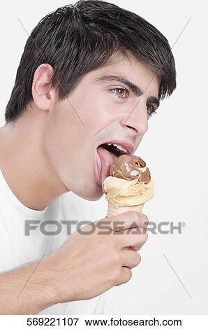 Close-up of a man eating an ice cream View Large Photo Image Stock Photo - Close-up of a man eating an ice cream. Fotosearch