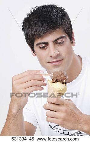 Stock Photography - Close-up of a man eating an ice cream. Fotosearch