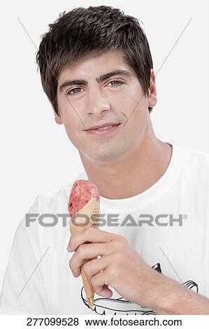 Close-up of a man holding an ice cream View Large Photo Image Stock Photo - Close-up of a man holding an ice cream. Fotosearch