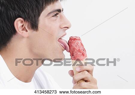 Close-up of a man licking an ice cream View Large Photo Image Stock Image - Close-up of a man licking an ice cream. Fotosearch