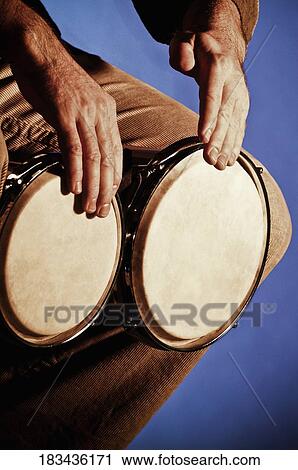 Close-up of a man playing a bongo View Large Photo Image Stock Image - Close-up of a man playing a bongo. Fotosearch