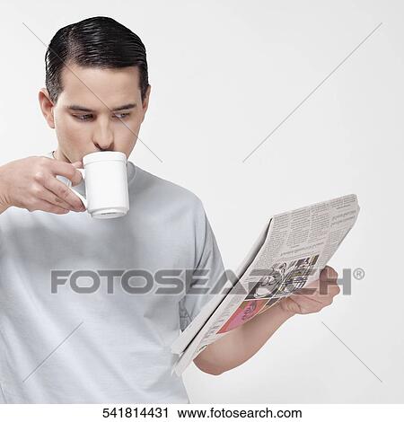 Close-up of a man reading a newspaper and drinking coffee View Large Photo Image Stock Image - Close-up of a man reading a newspaper and drinking coffee. Fotosearch