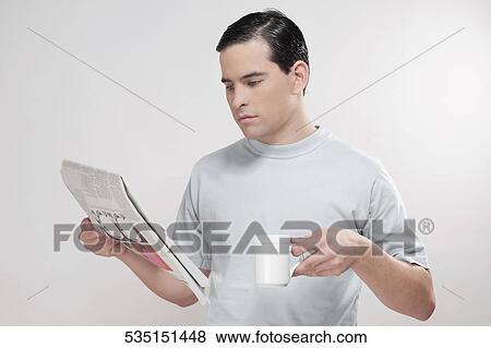 Stock Photo - Close-up of a man reading a newspaper. Fotosearch