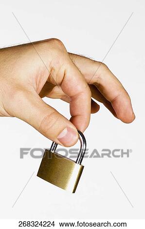 Picture - Close-up of a man's hand holding a padlock. Fotosearch