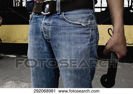 Close-up of a man's hand holding a telephone receiver View Large Photo Image Stock Image - Close-up of a man's hand holding a telephone receiver. Fotosearch