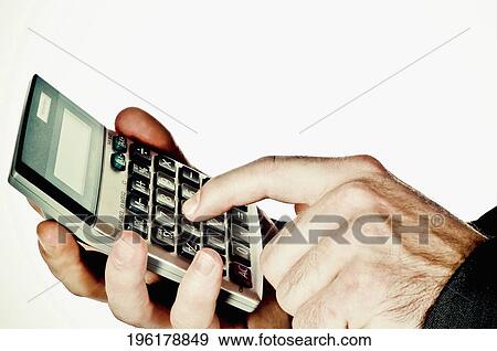 Close-up of a man's hand using a calculator View Large Photo Image Stock Photo - Close-up of a man's hand using a calculator. Fotosearch