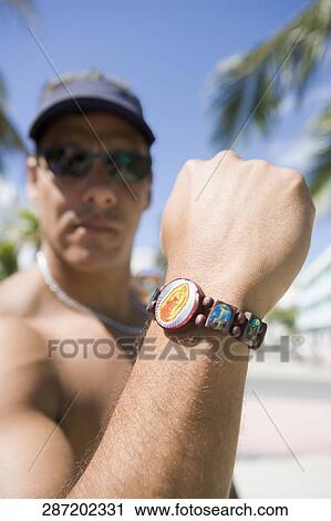 Close-up of a mature man showing a bracelet View Large Photo Image Stock Image - Close-up of a mature man showing a bracelet. Fotosearch