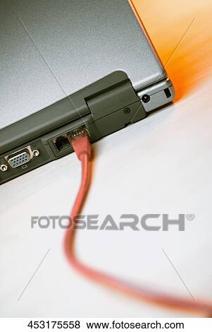 Stock Photo - Close-up of a network cable plugged into a laptop. Fotosearch