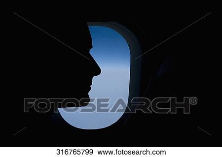 Stock Photo - Close-up of a passenger in an airplane. Fotosearch