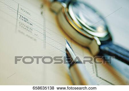 Close-up of a pen and a wristwatch on a file View Large Photo Image Stock Photo - Close-up of a pen and a wristwatch on a file. Fotosearch