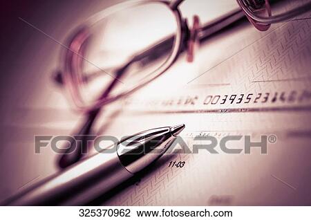 Close-up of a pen and eyeglasses on a check View Large Photo Image Stock Image - Close-up of a pen and eyeglasses on a check. Fotosearch