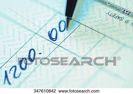 Stock Image - Close-up of a pen filling amount on a check. Fotosearch