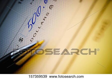 Close-up of a pen on a check View Large Photo Image Stock Photo - Close-up of a pen on a check. Fotosearch