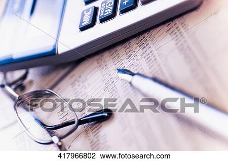 Close-up of a pen with a calculator and eyeglasses on a financial newspaper View Large Photo Image Stock Image - Close-up of a pen with a calculator and eyeglasses on a financial newspaper. Fotosearch