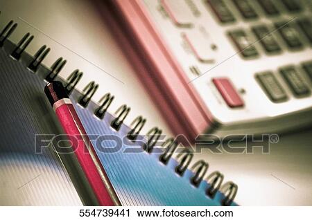 Close-up of a pencil and a spiral notebook and a calculator View Large Photo Image Stock Image - Close-up of a pencil and a spiral notebook and a calculator. Fotosearch