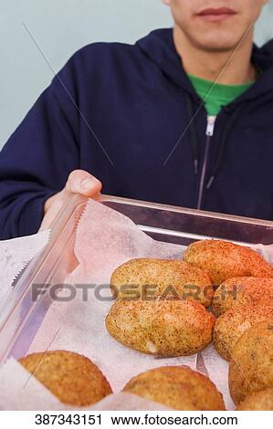 Close-up of a person holding buns in a tray View Large Photo Image Stock Image - Close-up of a person holding buns in a tray. Fotosearch