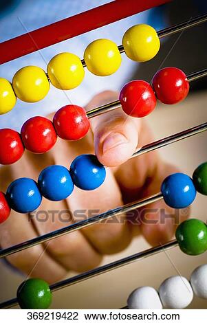 Close-up of a person's hand counting the beads of an abacus View Large Photo Image Stock Image - Close-up of a person's hand counting the beads of an abacus. Fotosearch