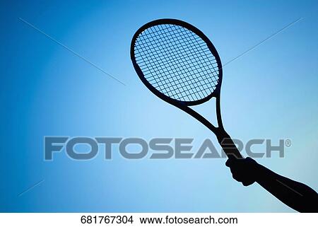 Picture - Close-up of a person's hand holding a tennis racket. Fotosearch