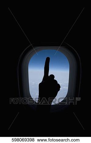 Close-up of a person's hand in front of an airplane window View Large Photo Image Stock Photo - Close-up of a person's hand in front of an airplane window. Fotosearch