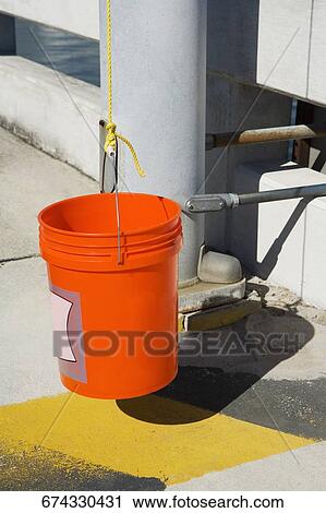 Close-up of a plastic bucket hanging from a rope View Large Photo Image Stock Image - Close-up of a plastic bucket hanging from a rope. Fotosearch