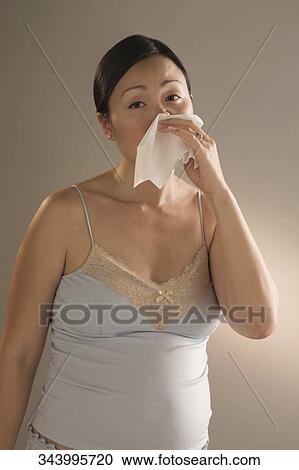 Close-up of a pregnant woman sneezing View Large Photo Image Stock Image - Close-up of a pregnant woman sneezing. Fotosearch