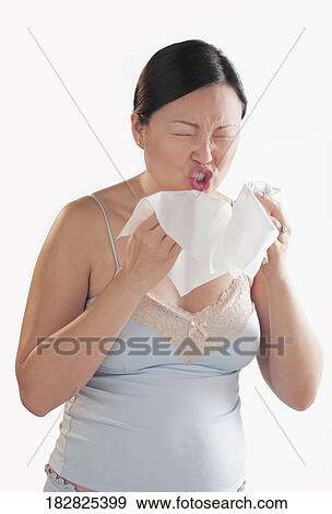 Close-up of a pregnant woman sneezing View Large Photo Image Stock Photo - Close-up of a pregnant woman sneezing. Fotosearch