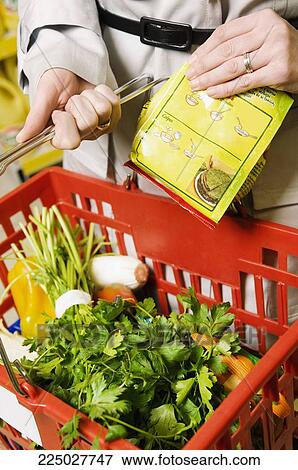 Stock Photo - Close-up of a shopping basket filled with vegetables. Fotosearch