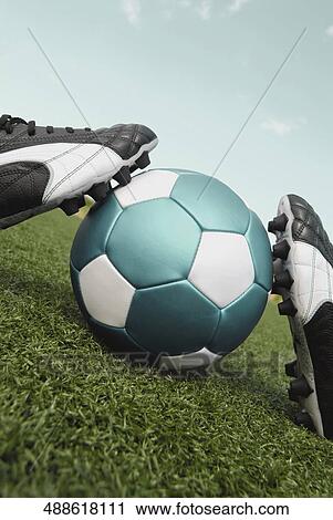 Close-up of a soccer ball and a pair of shoes View Large Photo Image Stock Image - Close-up of a soccer ball and a pair of shoes. Fotosearch