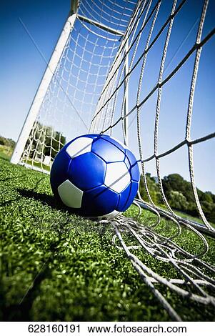 Stock Image - Close-up of a soccer ball in the net. Fotosearch