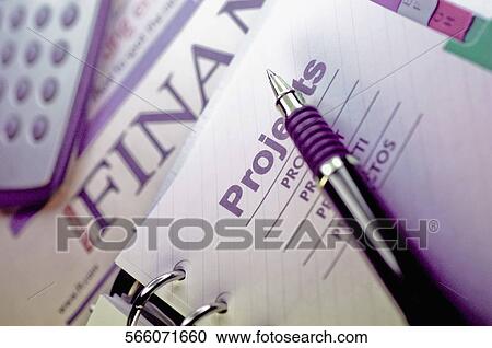 Close-up of a spiral notebook with a pen and calculator View Large Photo Image Stock Image - Close-up of a spiral notebook with a pen and calculator. Fotosearch
