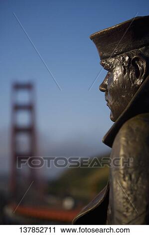 Close-up of a statue with a bridge in the background, The Lone Sailor, Golden Gate Bridge, San Francisco Bay, San Francisco, California, USA View Large Photo Image Stock Image - Close-up of a statue with a bridge in the background, The Lone Sailor, Golden Gate Bridge, San Francisco Bay, San Francisco, California, USA. Fotosearch