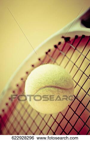 Stock Photograph - Close-up of a tennis ball and a tennis racket. Fotosearch