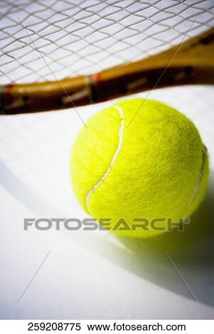 Close-up of a tennis racket and a tennis ball View Large Photo Image Stock Photography - Close-up of a tennis racket and a tennis ball. Fotosearch