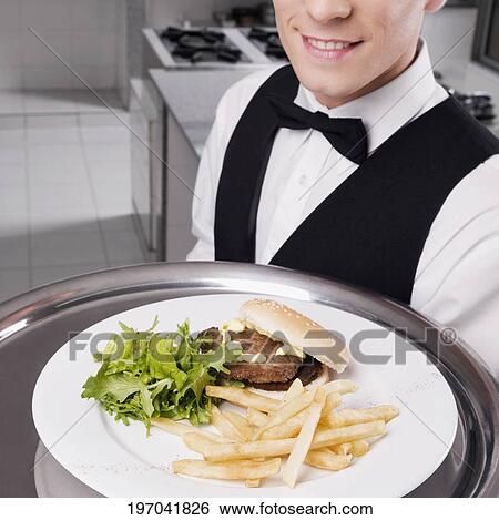 Stock Photograph - Close-up of a waiter holding a tray of snacks. Fotosearch
