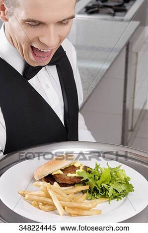 Close-up of a waiter holding a tray of snacks View Large Photo Image Stock Photography - Close-up of a waiter holding a tray of snacks. Fotosearch