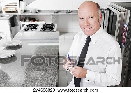 Close-up of a waiter taking orders View Large Photo Image Stock Photo - Close-up of a waiter taking orders. Fotosearch